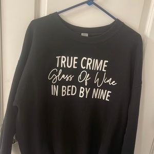 True crime, glass of wine, bed by 9 sweatshirt